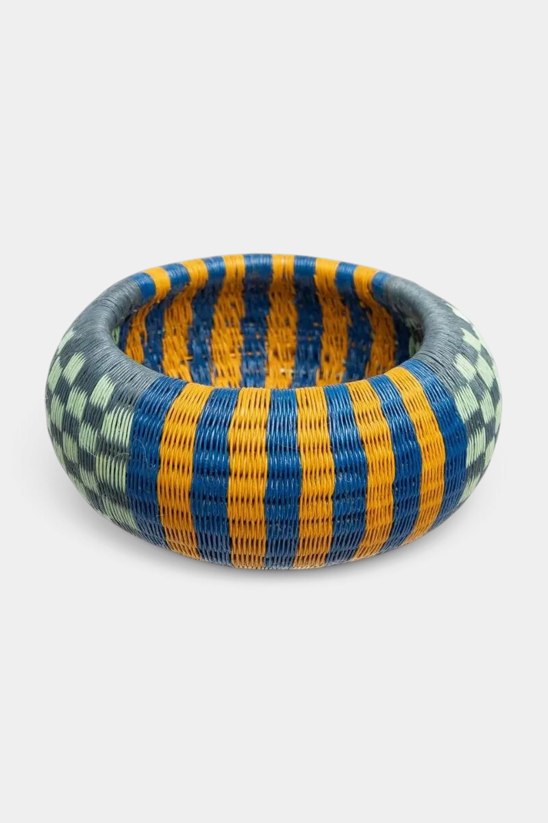 The Copper Shed handwoven Werregue bracelet featuring blue, yellow, and green geometric patterns in natural palm fiber.