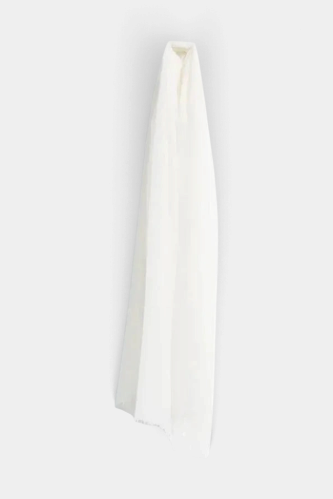 The Copper Shed white featherweight cashmere stole scarf with a sheer, elegant, and airy felted texture.