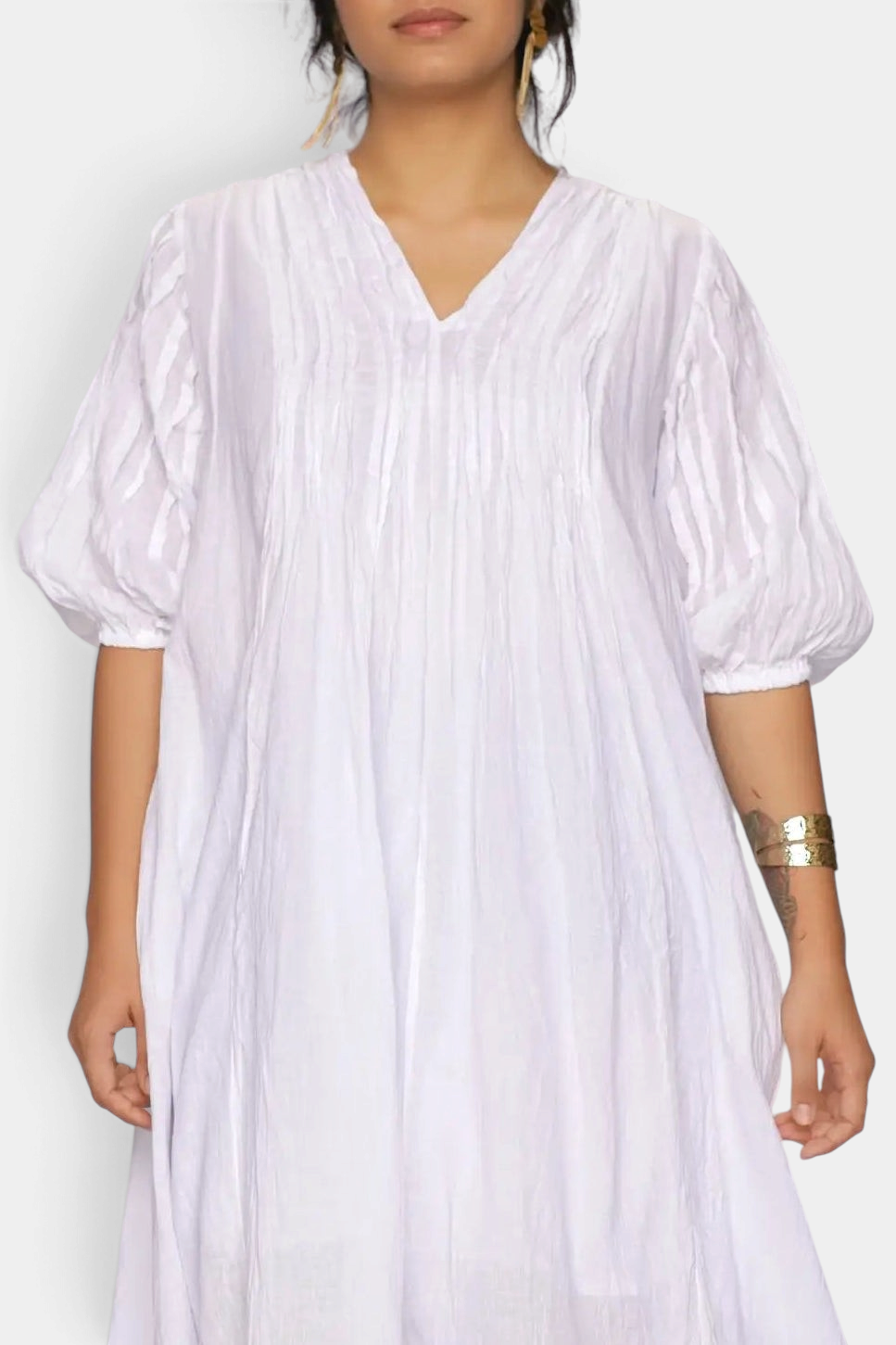 The Copper Shed white cotton gauze A-line dress with puff sleeves, V-neckline, and pin-tuck detailing.