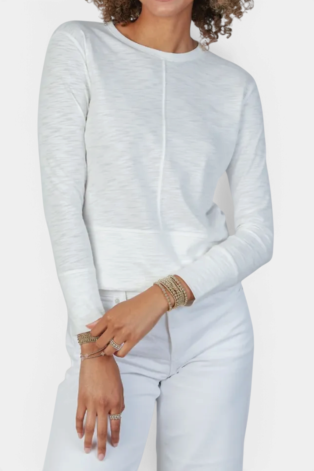 The Copper Shed Celia white long sleeve Pima cotton slub tee with double-layered cuffs worn with white jeans.