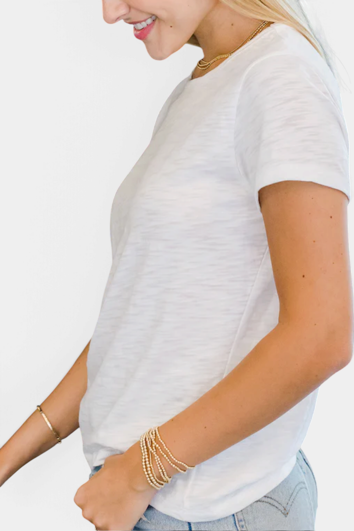 The Copper Shed white Pima cotton slub short sleeve tee worn by a woman with gold jewelry against a white background