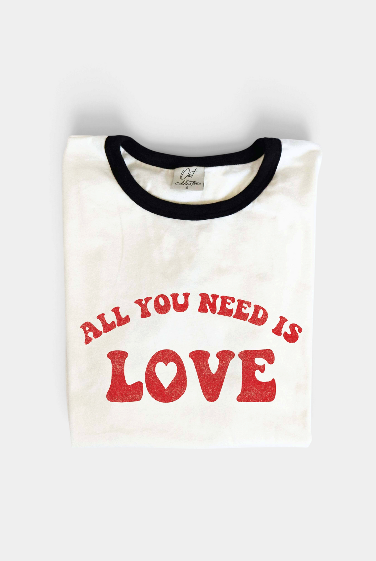 The Copper Shed white ringer t-shirt with black neck trim and red ALL YOU NEED IS LOVE graphic in seventies font