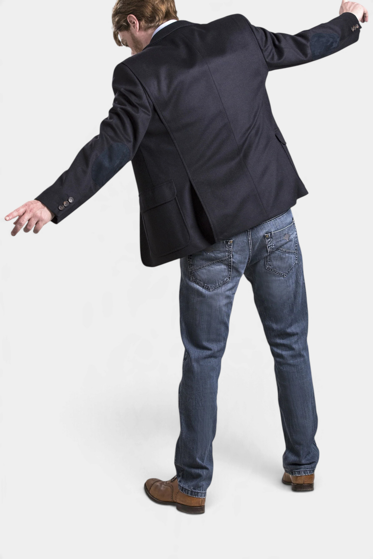 The Copper Shed Wilfred navy blue wool and alpaca blazer with elbow patches, viewed from the back on a model.