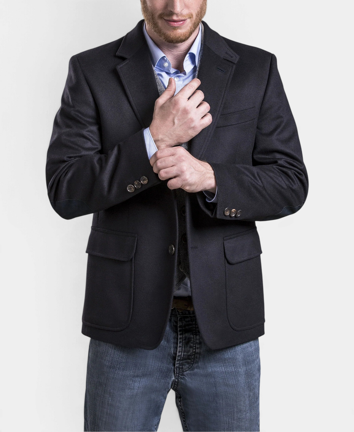 The Copper Shed Wilfred navy blue wool and alpaca blazer with shoulder pleats worn by a man over a light blue shirt