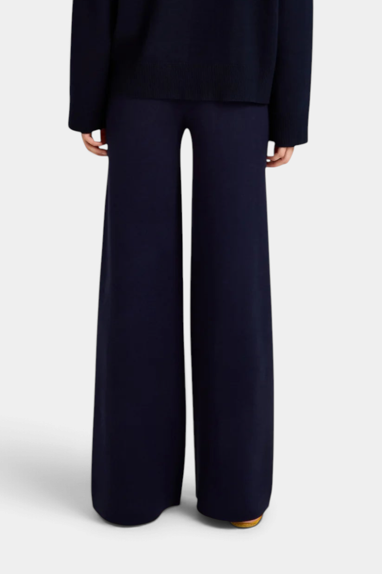 The Copper Shed Winnie pant in navy blue, featuring a structured knit boot-leg silhouette and elastic waistband.