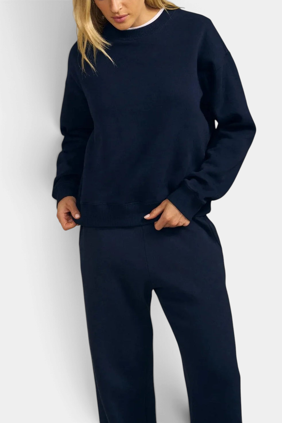 The Copper Shed Yoko navy cotton sweatshirt with drop shoulders and crew neck worn by a woman